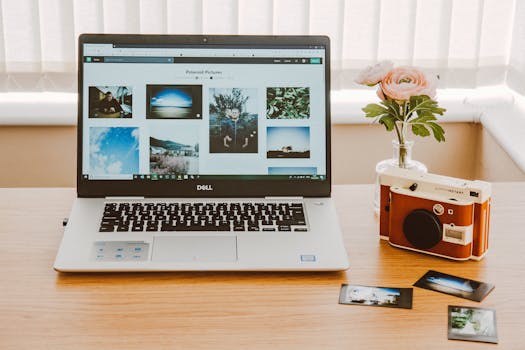 Black and Gray Dell Laptop Beside Camera