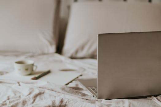 Laptop and Notes on Bed