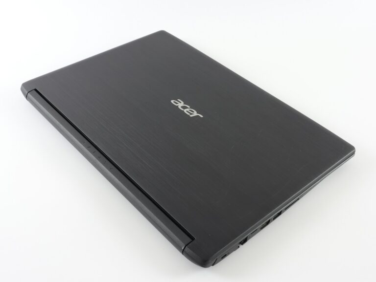 a laptop computer sitting on top of a white table